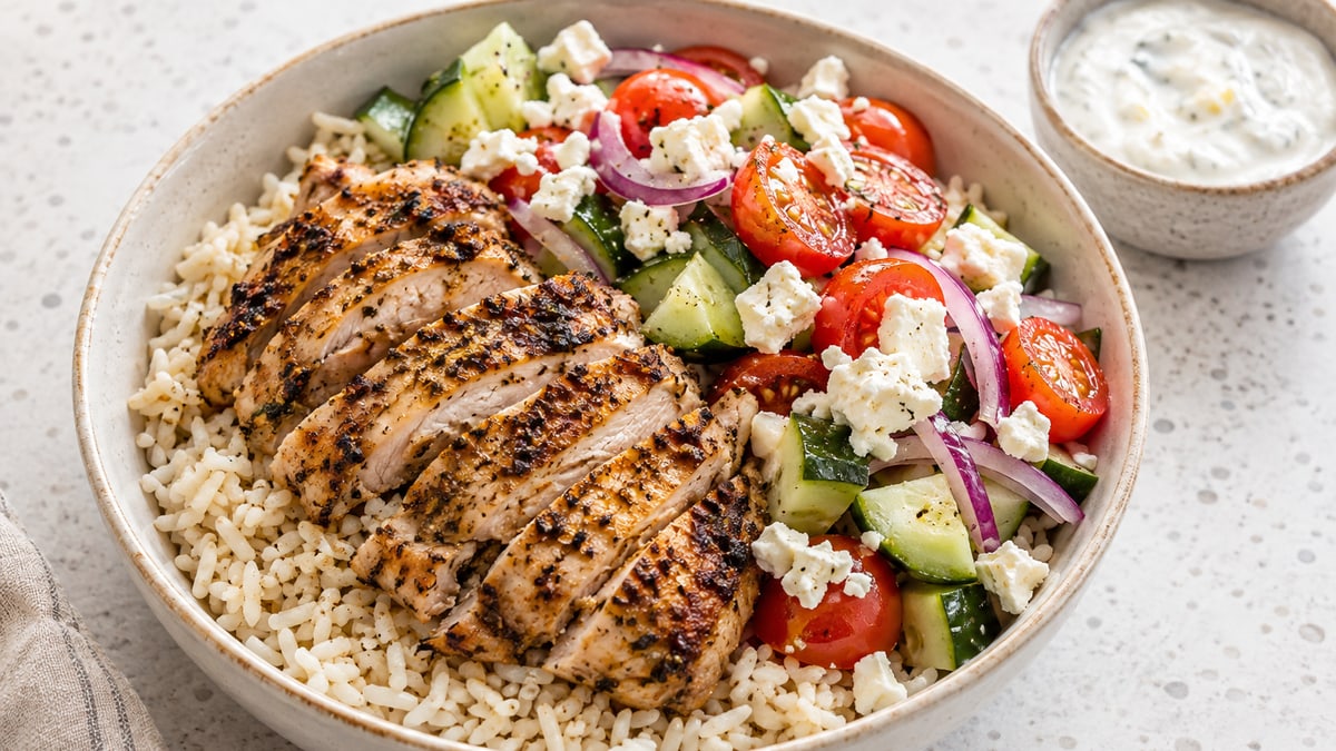 Greek Chicken & Rice Bowls, cooked and served. A generated image, not a photograph.