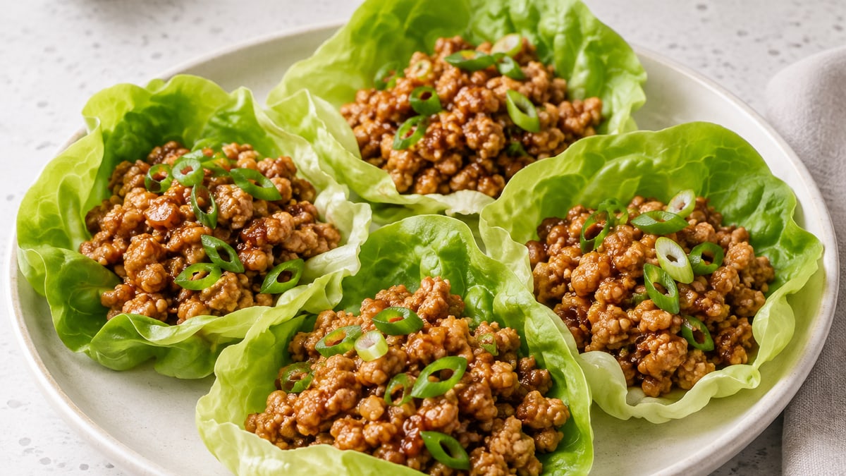 Honey Sriracha Chicken Lettuce Cups, cooked and served. A generated image, not a photograph.
